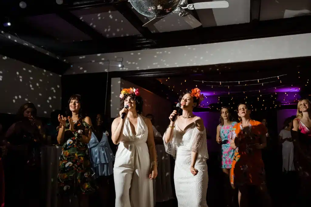 Women singing using Karaoke rentals at a wedding reception